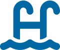 A blue letter h is sitting in front of water.